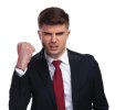 portrait-angry-businessman-shaking-his-fist-white-background-wears-navy-coloured-suit-red-tie-...jpg