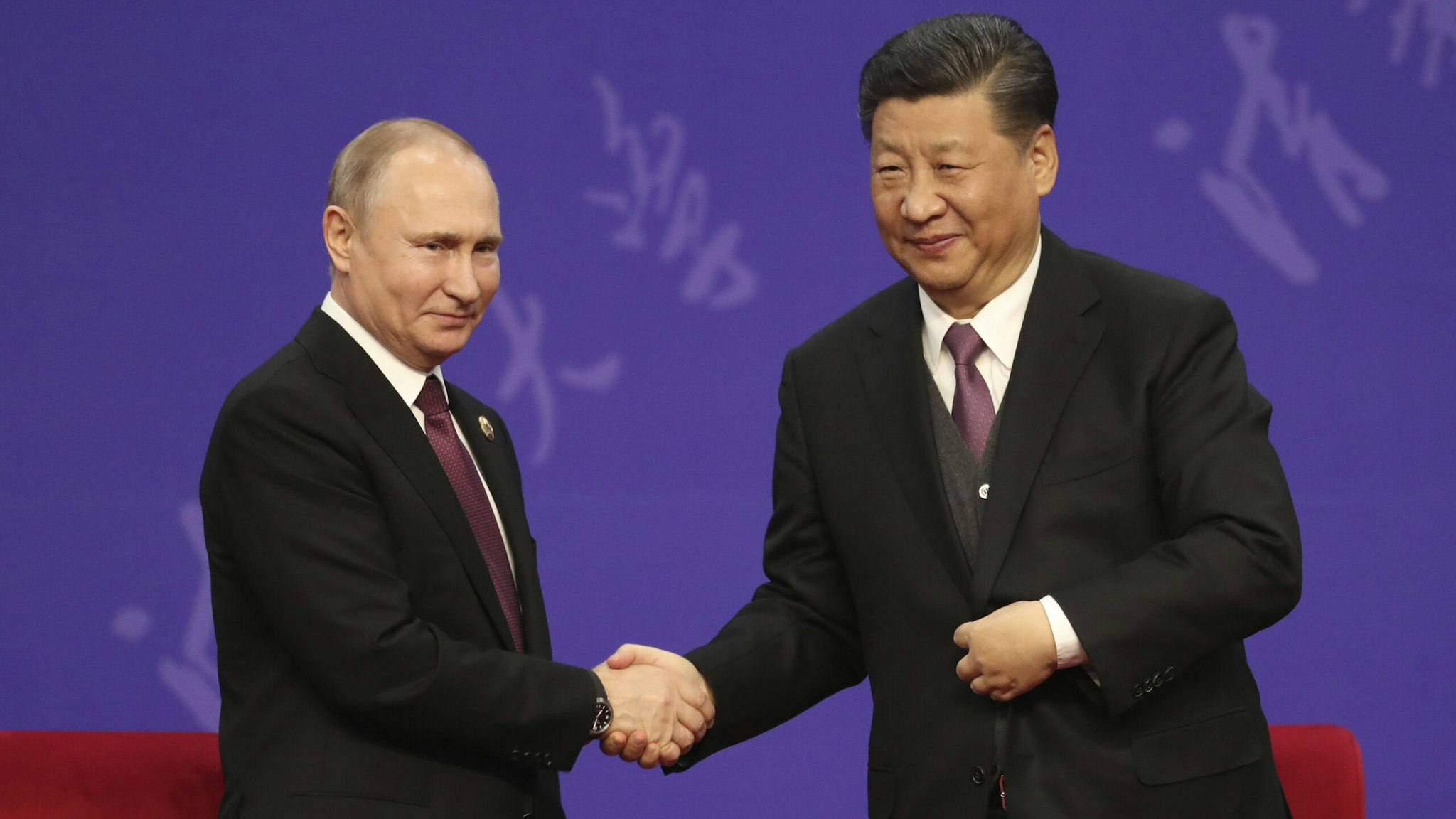 Russian President Vladimir Putin, left, shakes hands with Chinese President Xi Jinping, right, during the Tsinghua Universitys ceremony, at Friendship palace on April 26, 2019 in Beijing, China.