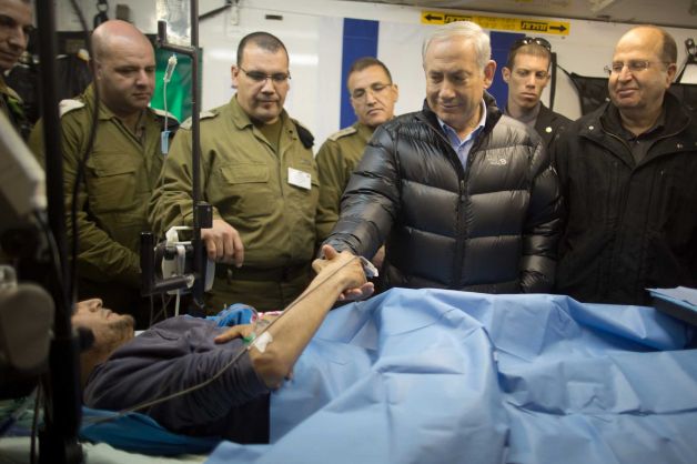 israeli-prime-minister-benjamin-netanyahu-next-to-a-wounded-mercenary-israeli-military-field-hospital-at-the-occupied-golan-heights-border-with-syria-18-february-2014.jpg